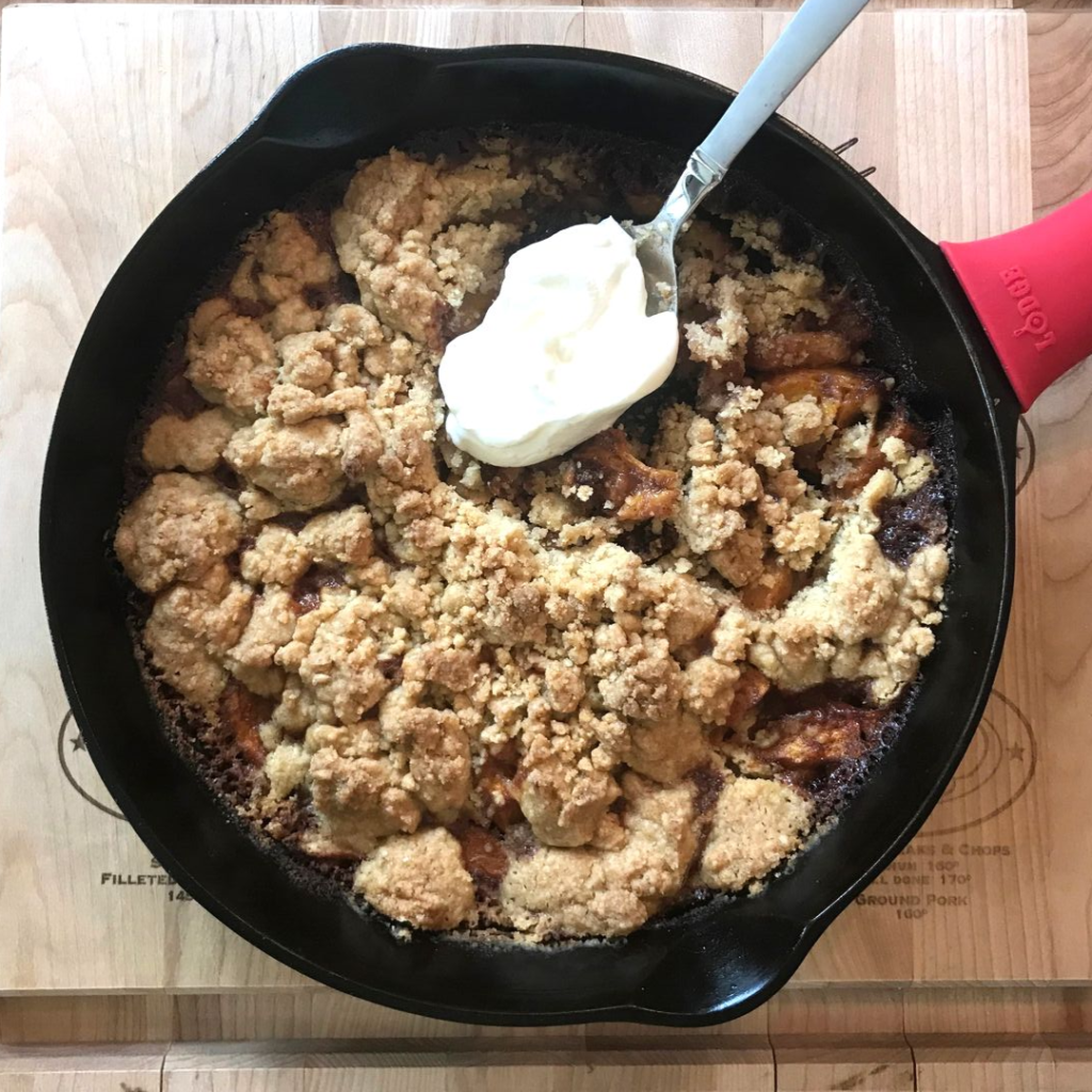 Peaches and cream crumble on cast iron skillet