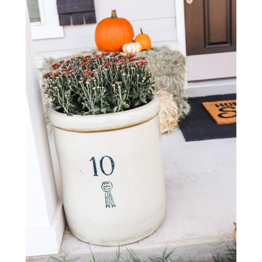 10 gallon crock used as a planter for mums during fall 