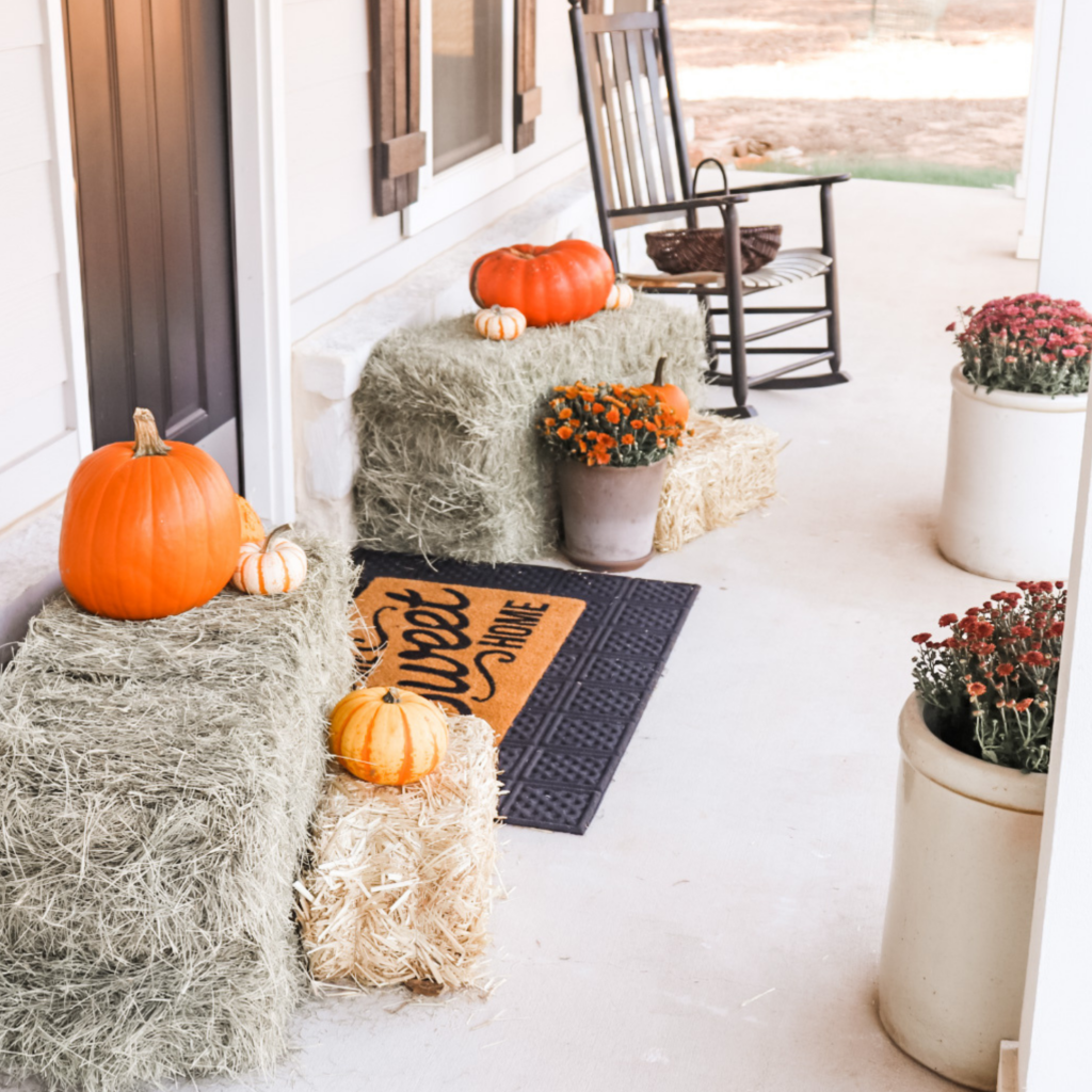 Front doorway bales pumpkins and mums. fall front porch decorations